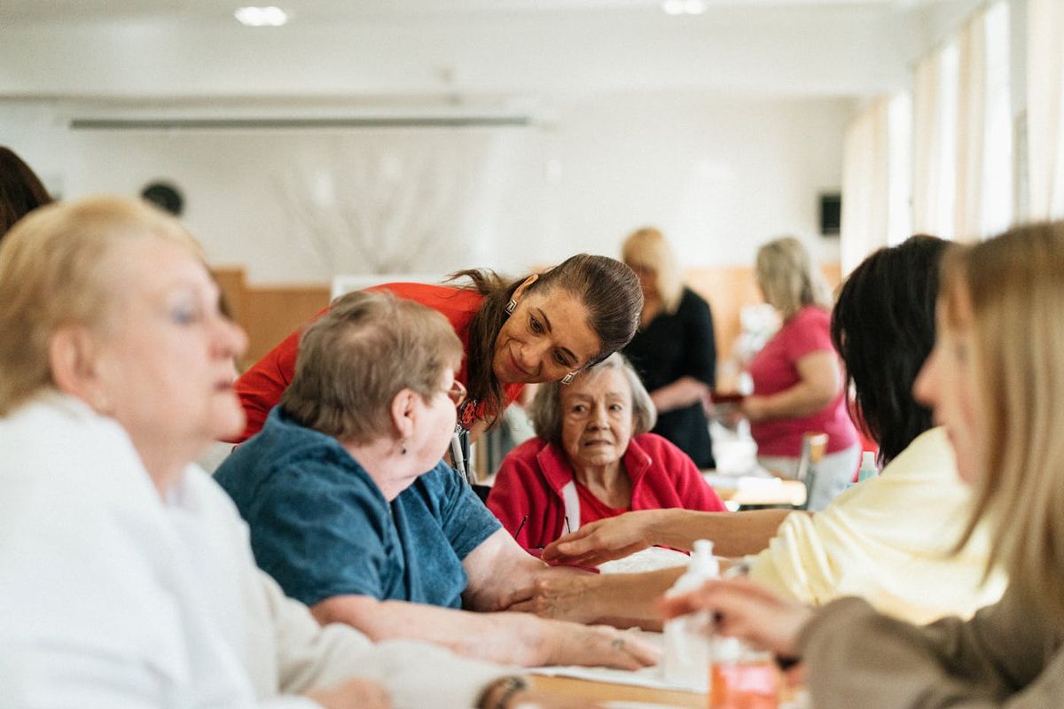 A facilitator working with a group of seniors at a community session